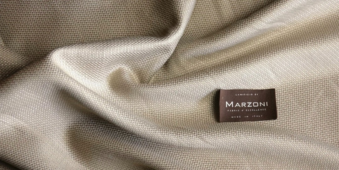 Close-up of Marzoni luxury Italian fabric featuring the Marzoni label, highlighting premium cloth selected for custom suits, sport coats, and bespoke menswear.