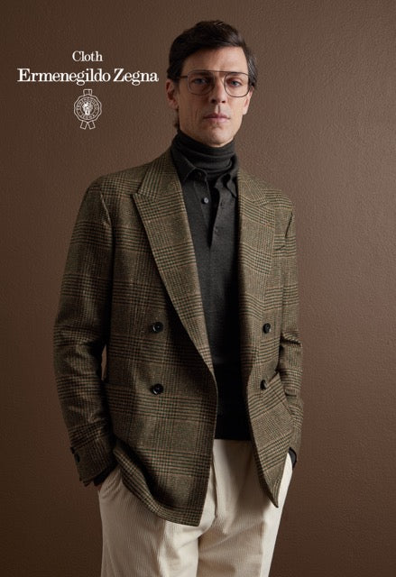 Model wearing a brown glen check double-breasted jacket, dark knitwear and cream trousers; Ermenegildo Zegna cloth reference 67003.