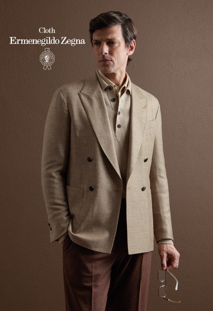Model wearing a beige double-breasted jacket, beige polo and brown trousers; Ermenegildo Zegna cloth reference 67018.