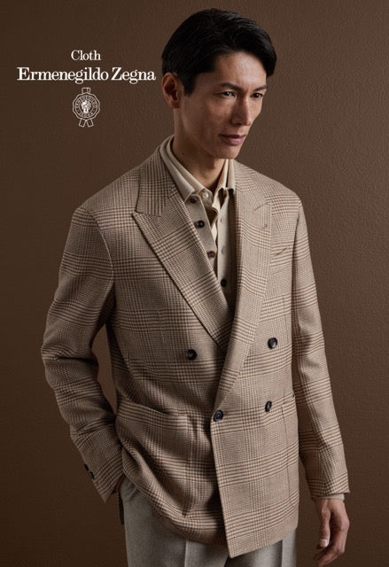 Model wearing a beige glen check double-breasted jacket over a beige polo; Ermenegildo Zegna cloth reference 67042.