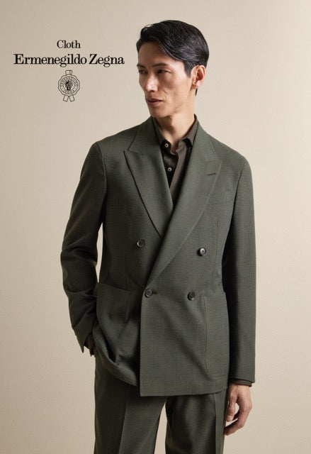 Model wearing an olive green double-breasted suit over a dark shirt; Ermenegildo Zegna cloth reference 67054.