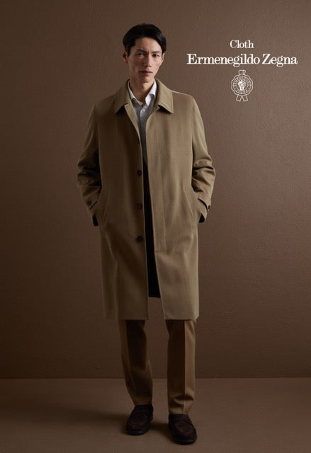 Model wearing a tan overcoat over a coordinating suit and white shirt; Ermenegildo Zegna cloth reference 67097.