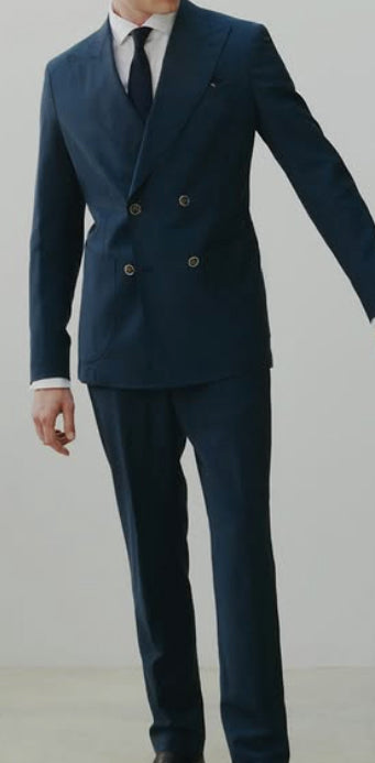 Navy double-breasted suit crafted from Dormeuil luxury fabric, featuring clean lines, peak lapels, and timeless tailored elegance.