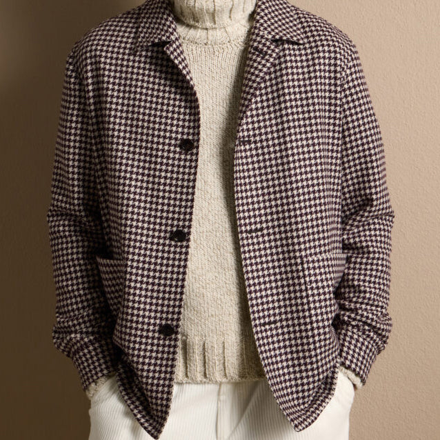 Brown houndstooth sport coat crafted from Ermenegildo Zegna Italian fabric, styled with a cream knit turtleneck for refined casual elegance.