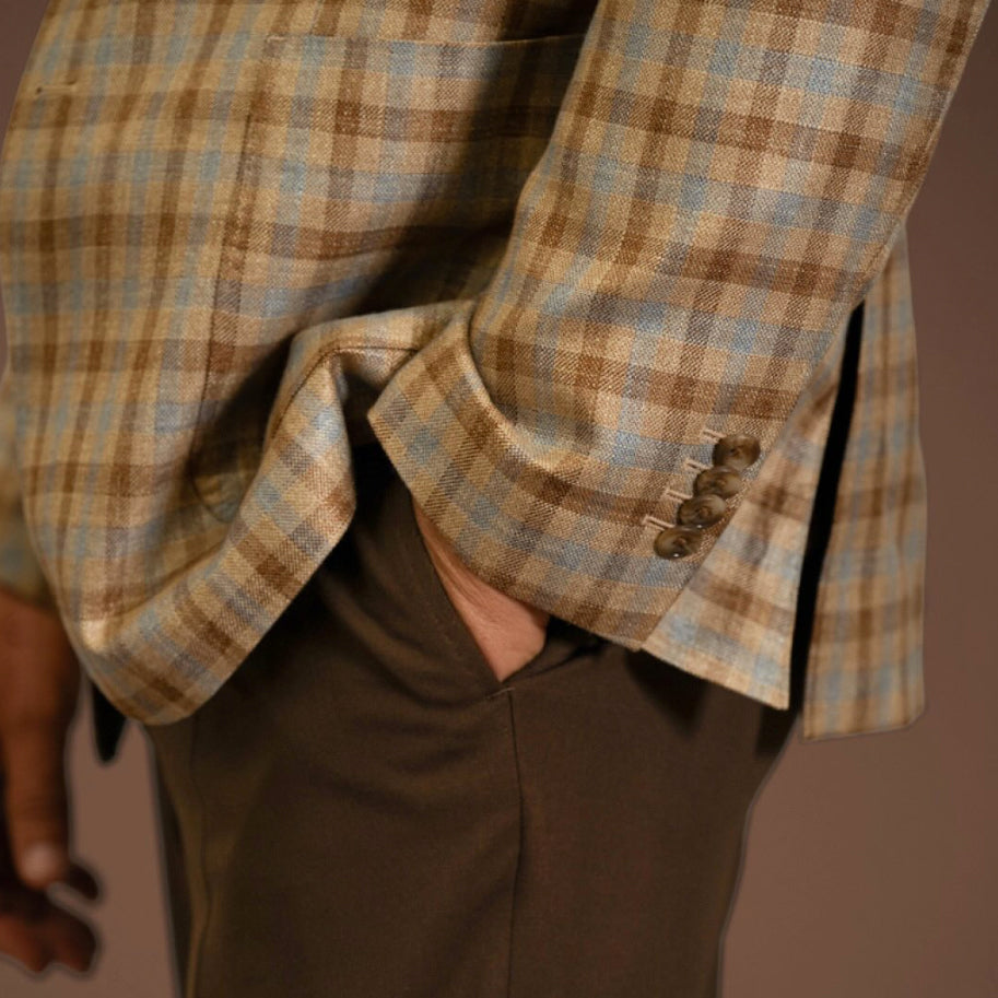 Detail of a Gladson bamboo sport coat, known as California Cashmere, showcasing a lightweight tan and blue check fabric with refined tailoring and luxury menswear styling.