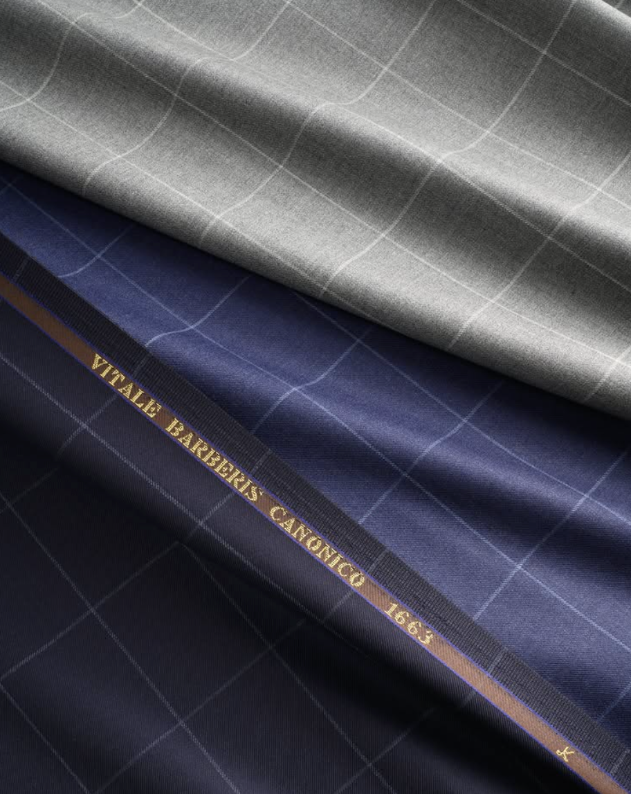 Vitale Barberis Canonico luxury Italian fabrics displayed in gray and navy windowpane designs, reflecting more than 350 years of exceptional textile craftsmanship.