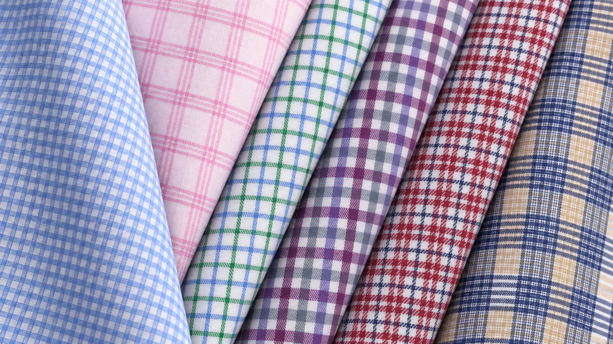 Envy shirting fabrics in blue, pink, green, purple and burgundy check patterns.