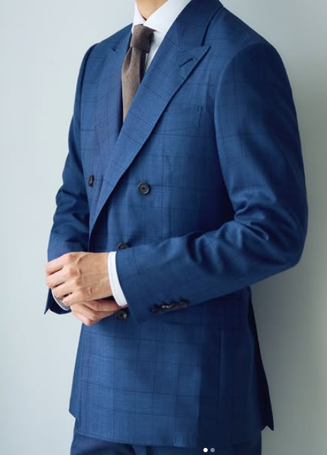 Blue plaid double-breasted suit styled with a white shirt and brown tie.