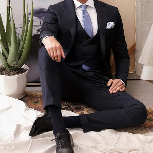 Marzoni navy three-piece suit in premium Italian fabric, showcasing refined tailoring and sophisticated styling for business, formal occasions, and custom wardrobe inspiration.
